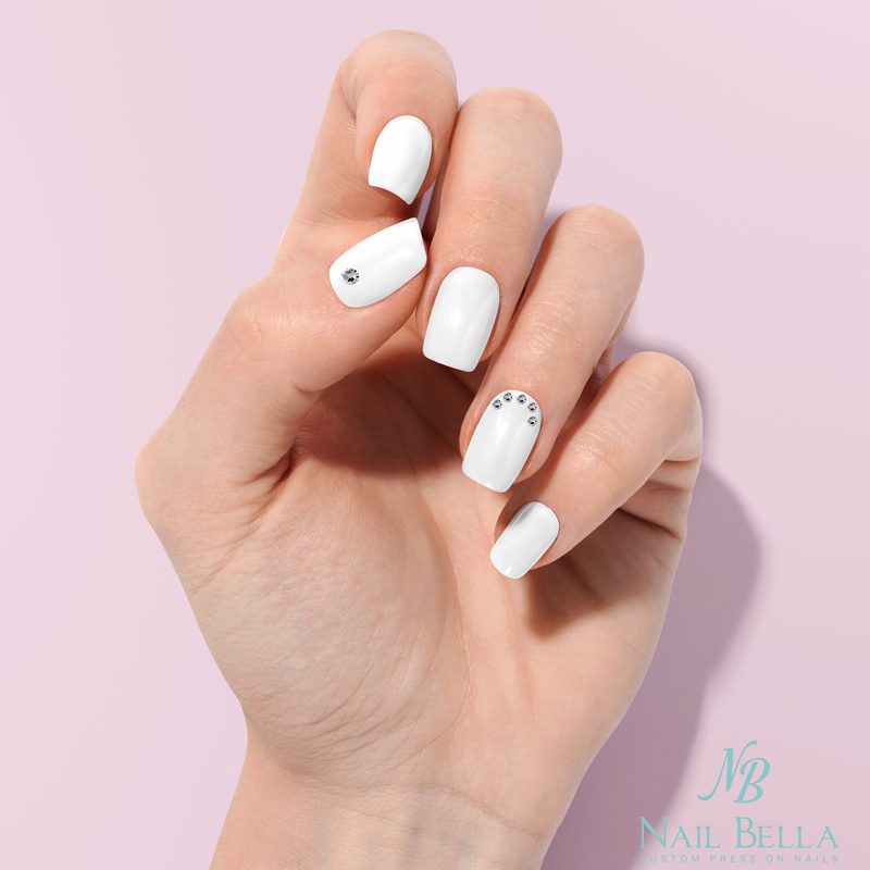 close-up of elegant white nail art design on manicured hands