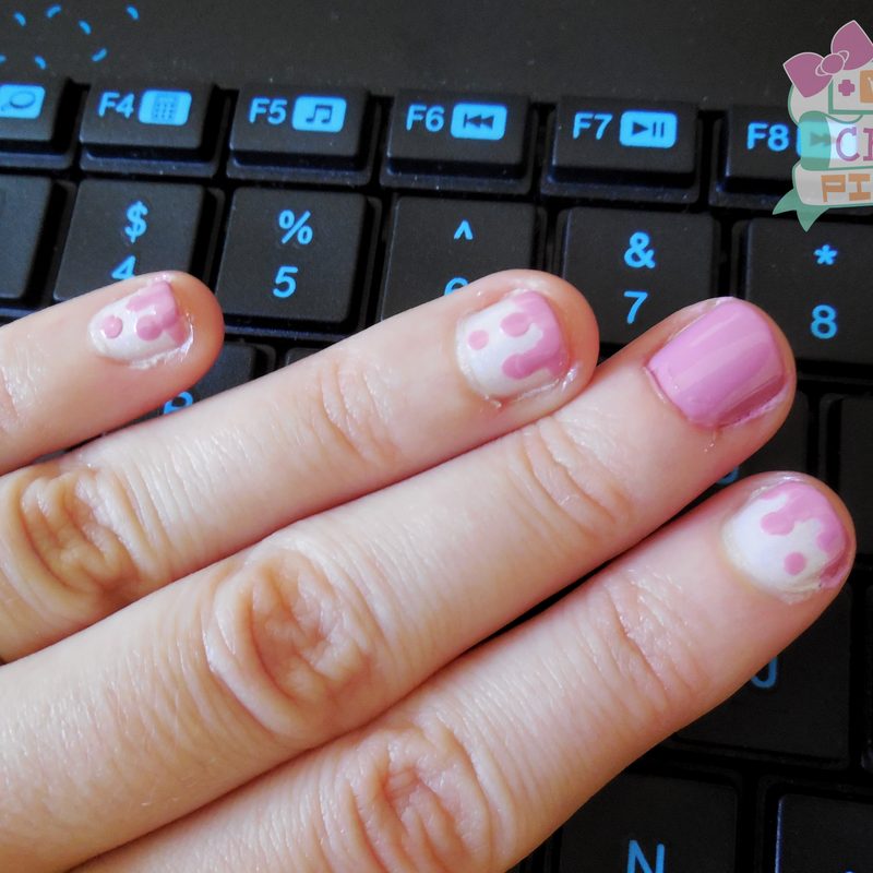 close-up of hands applying three color nail designs with nail art brushes