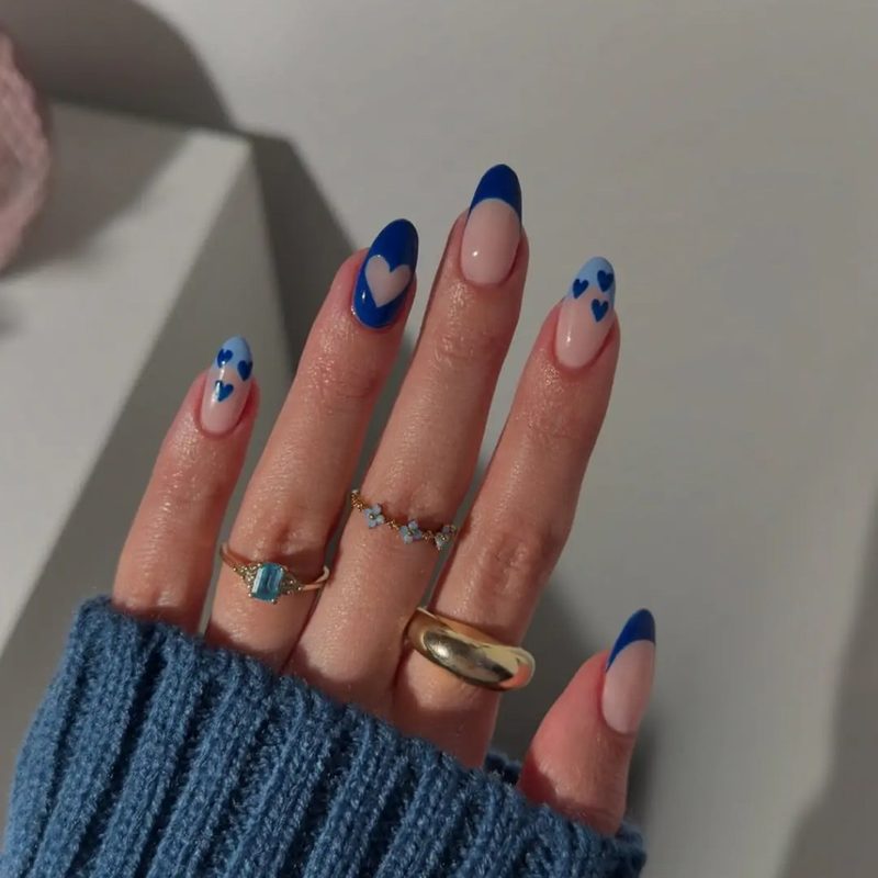 creative blue nail art combining matte and glossy finishes with floral accents