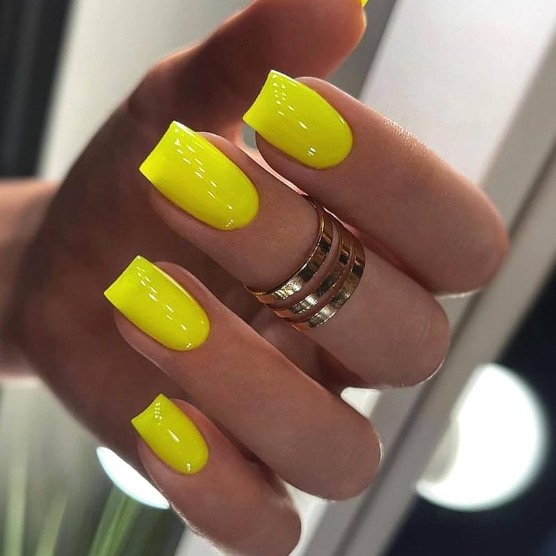 matte yellow nails with glossy nail art accents