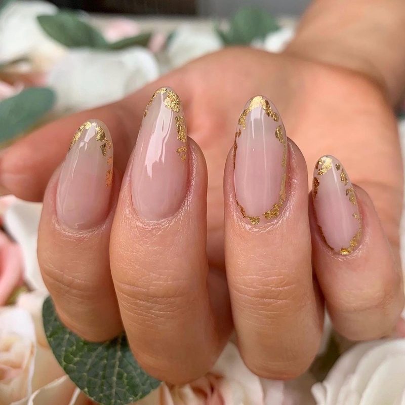 nude nails with delicate gold foil nail art accents