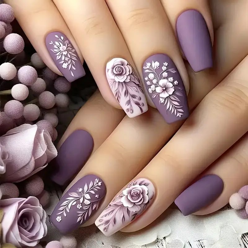 purple nails with floral and abstract swirl patterns