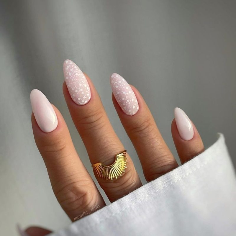 variety of trendy nail designs on white base with floral and geometric elements