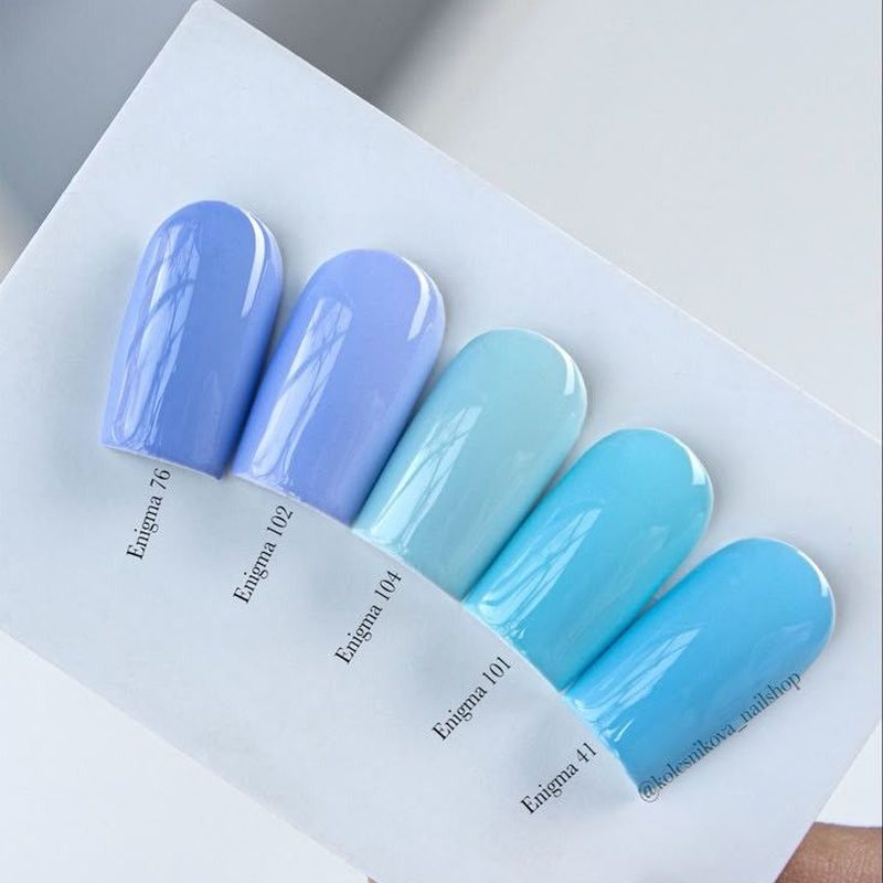 various shades of blue nail polish bottles showing diverse blue nail art options
