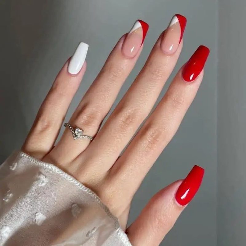 classic red nails showcasing white floral and geometric nail art