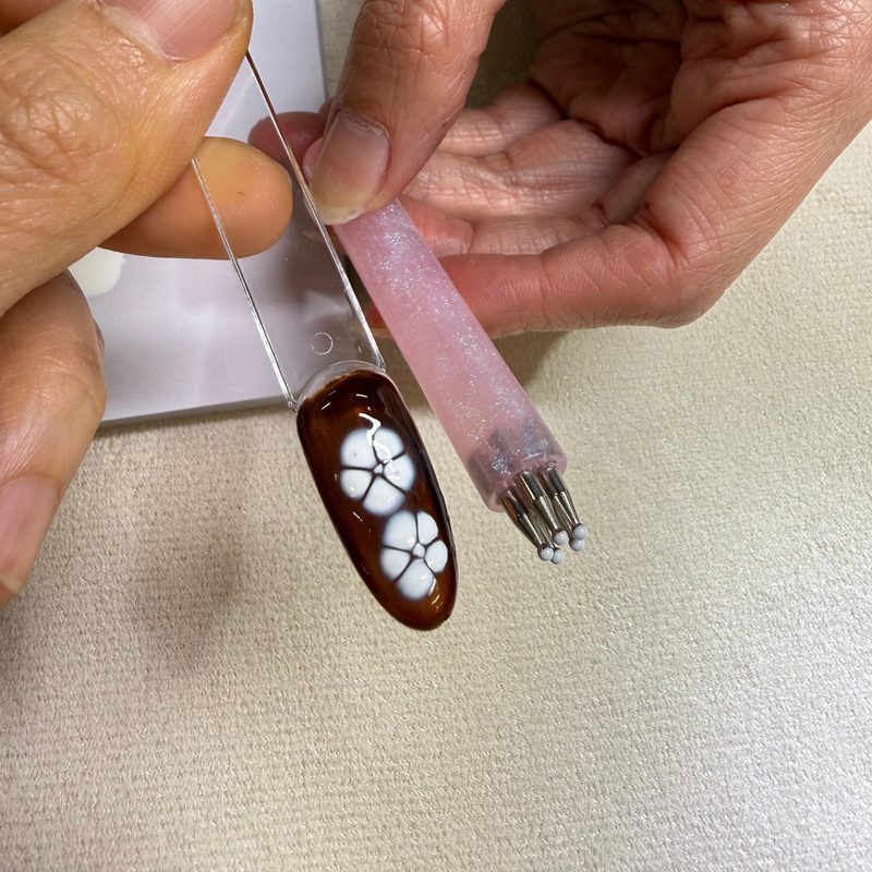 Close-up of a nail design wheel tool showcasing various manicure creativity