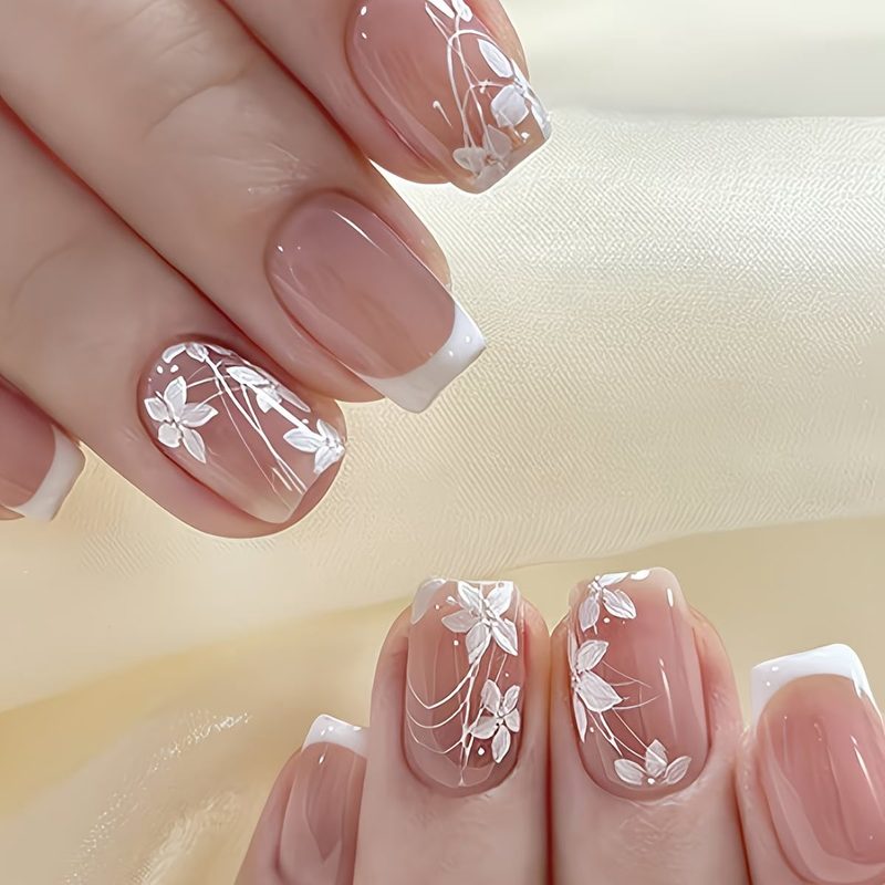 Elegant white press on nails with floral and geometric designs