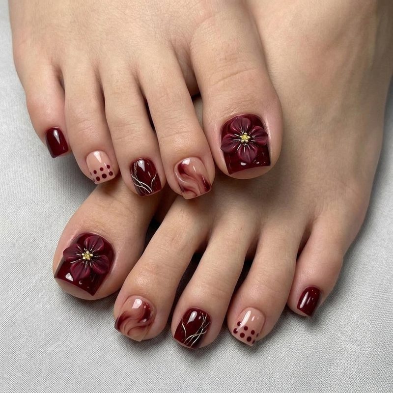 festive nail art featuring snowflakes and metallic accents on toes