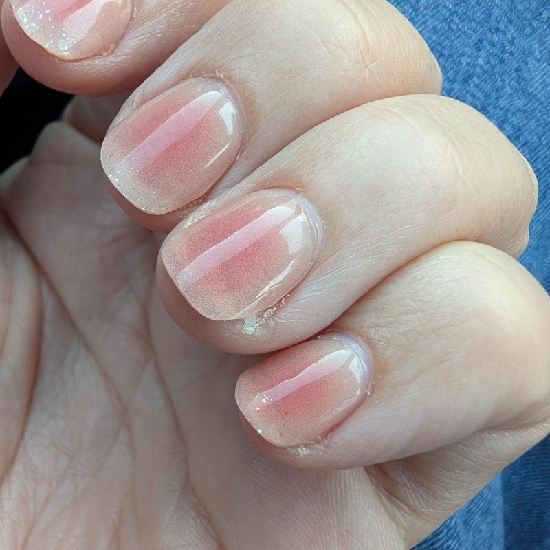 hand applying top coat for summer nail maintenance
