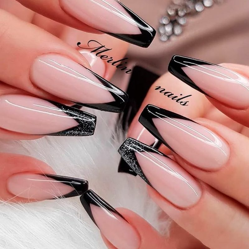 hand with art deco nail design featuring metallic accents and geometric shapes