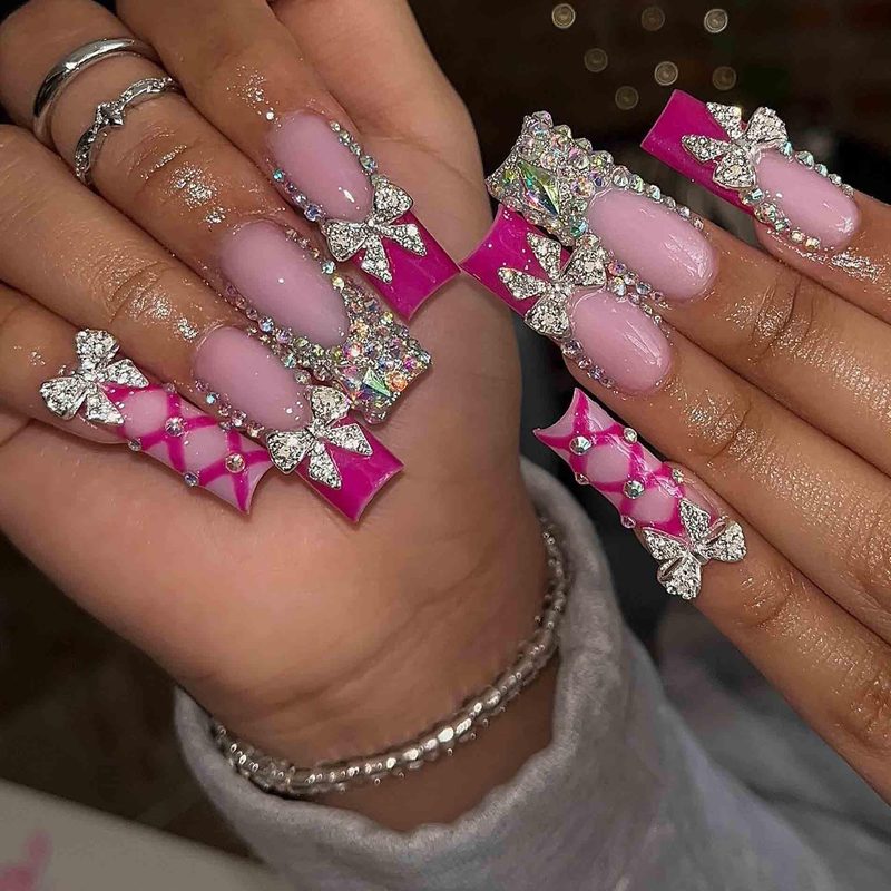 hot pink nail art featuring rhinestones and stamping techniques