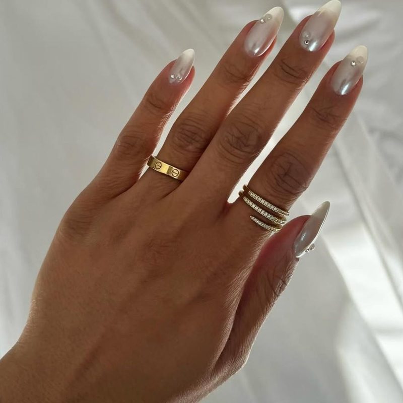 variety of pearl nail designs featuring French tips and 3D pearl embellishments